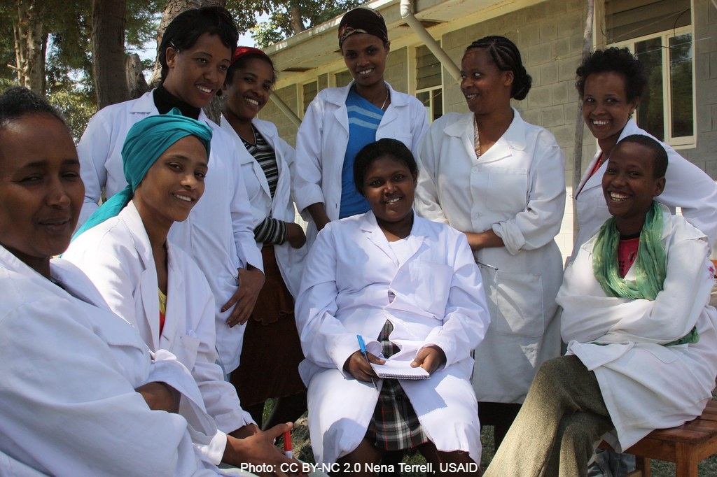 A group of nurses in white coats